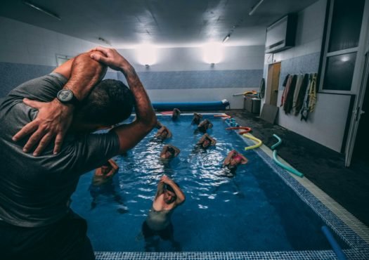 people stretching inside pool room
